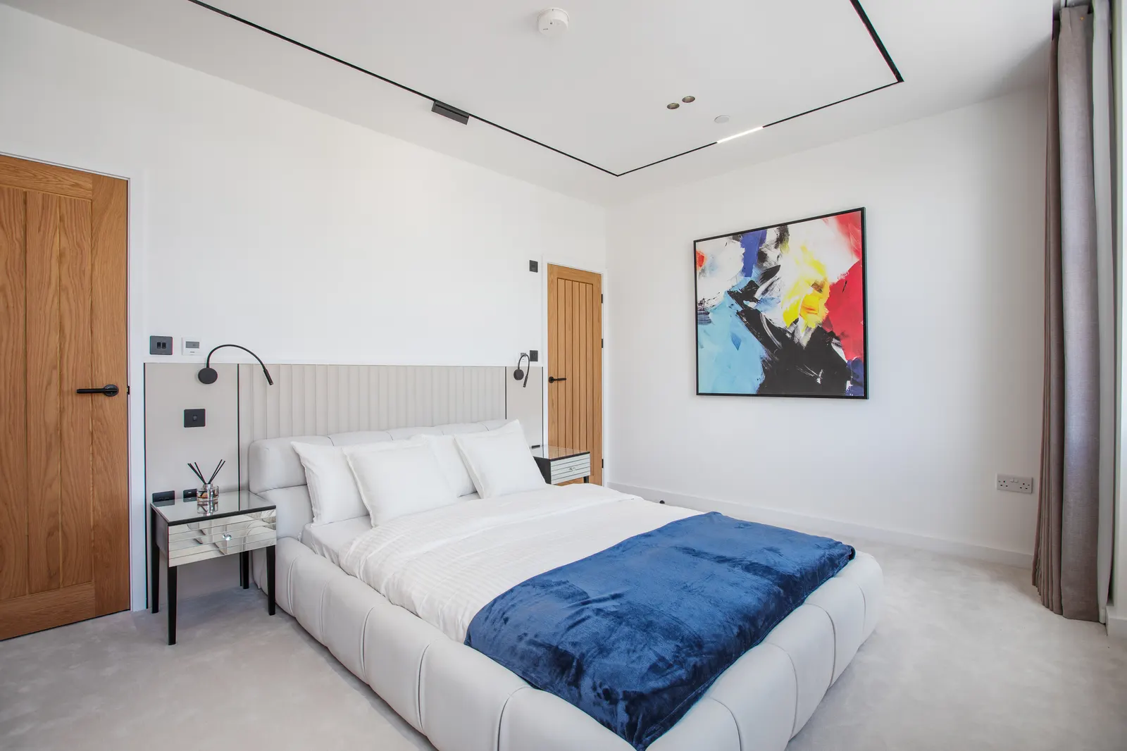 Bedroom with navy bed runner