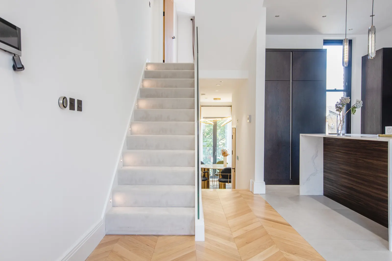 Staircase with white walls and timber treads