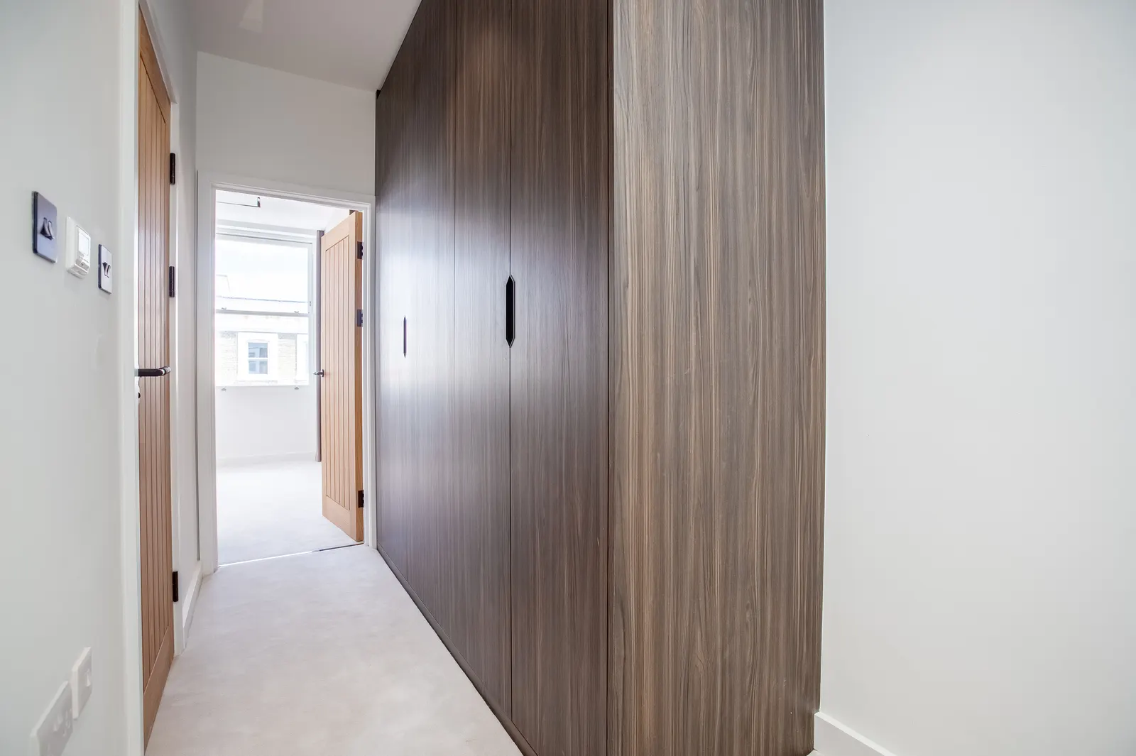 Hallway with timber doors and wardrobe