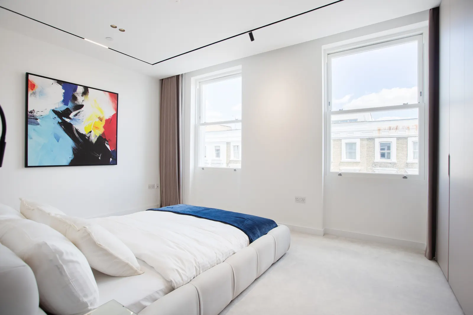 Bedroom with artwork above bed