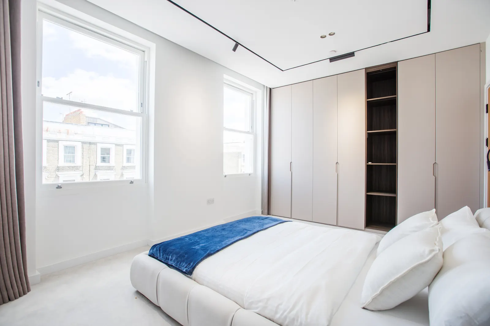 Bedroom with window seat and white linens