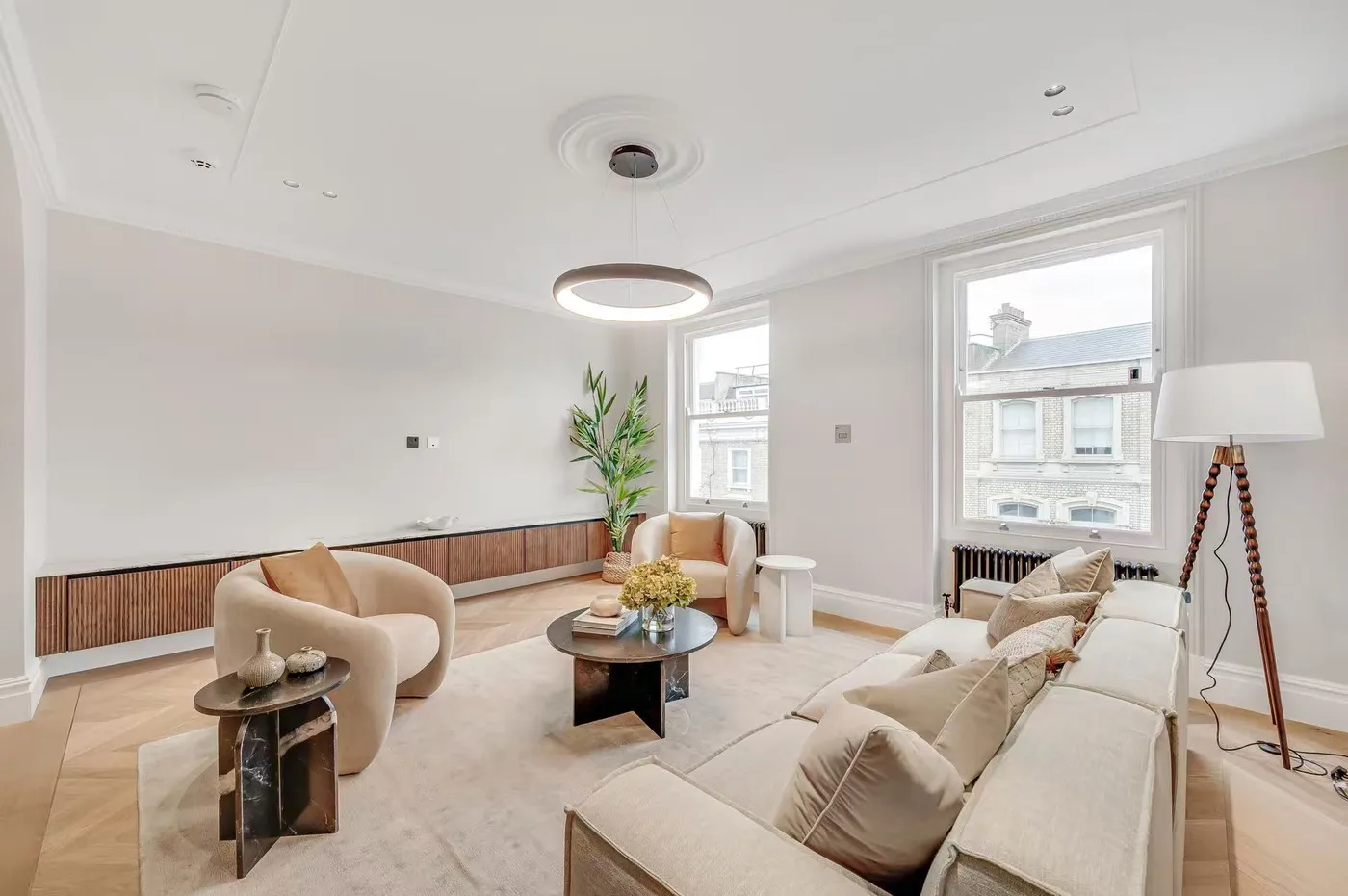 Living room with neutral sofas and timber flooring
