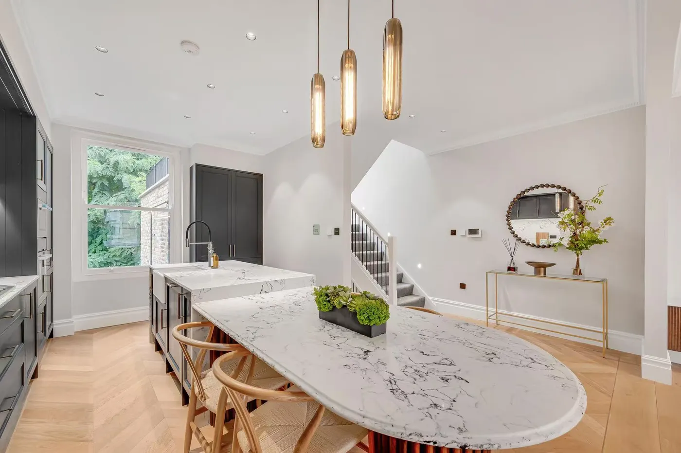 Dining area with marble table and leather chairs