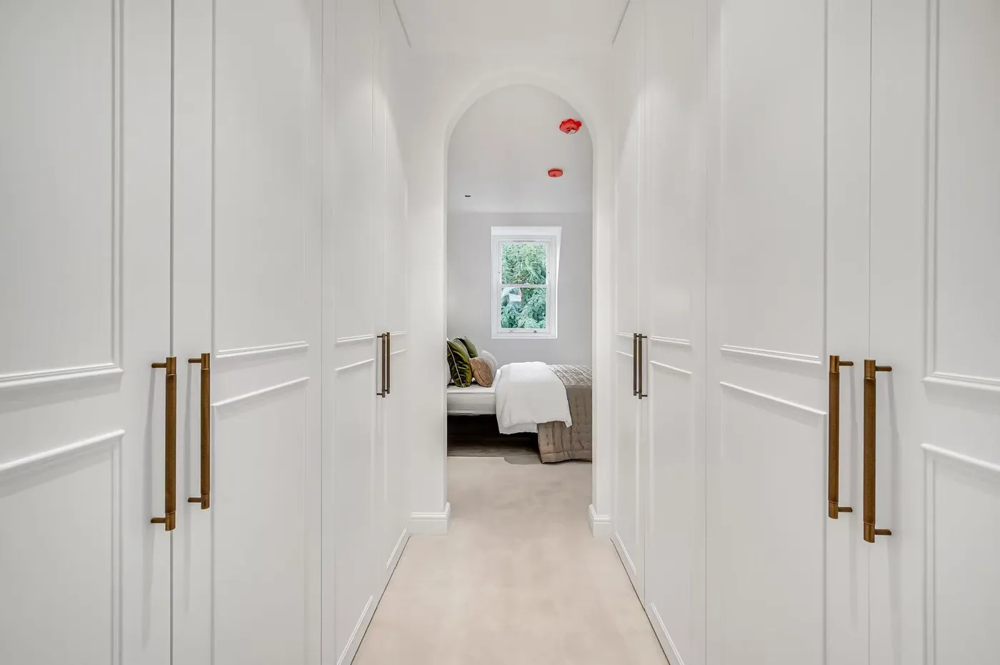 Hallway with arched doorways and panelled walls